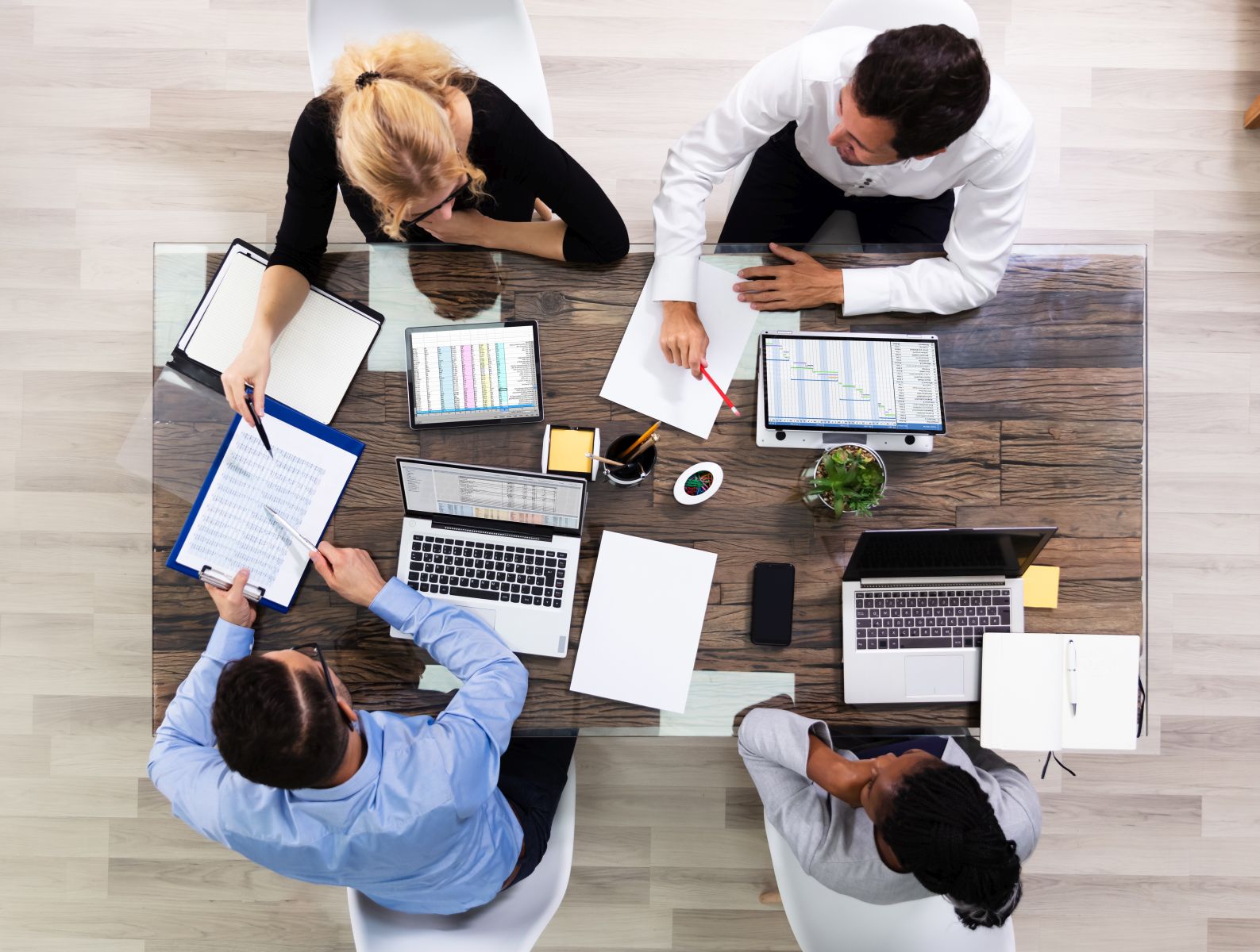 High Angle View Of A Team Of Corporate Executives Discussing About Data In Meeting Room